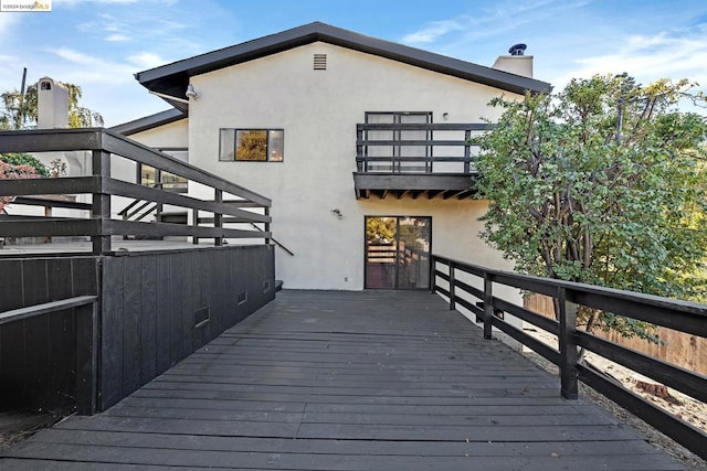 rear view of house featuring a deck