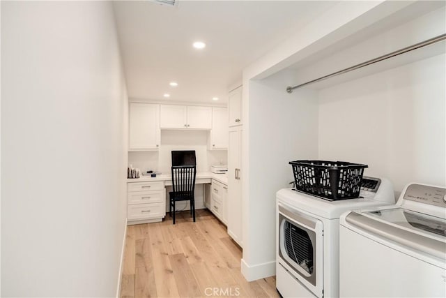 laundry area with independent washer and dryer and light hardwood / wood-style floors