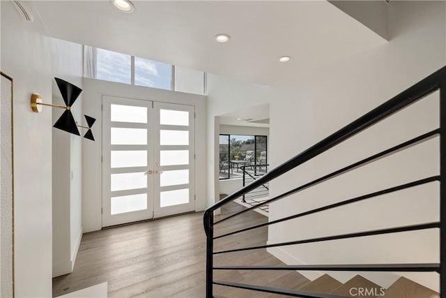 foyer entrance featuring french doors and light hardwood / wood-style floors