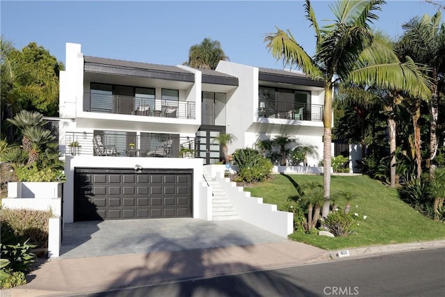 view of front of home with a garage and a front lawn