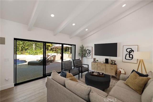 living room with lofted ceiling with beams and light hardwood / wood-style floors