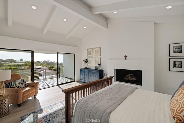 bedroom with access to exterior, lofted ceiling with beams, and hardwood / wood-style floors