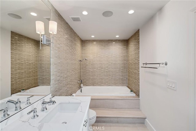 full bathroom featuring vanity, tiled shower / bath combo, tile patterned floors, and toilet