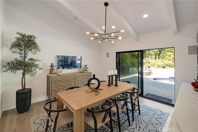 dining space with vaulted ceiling with beams, a notable chandelier, and light wood-type flooring