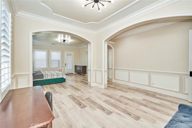 interior space featuring hardwood / wood-style floors, ornamental molding, and a chandelier