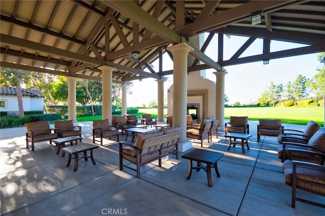 view of patio featuring a gazebo and an outdoor living space with a fireplace