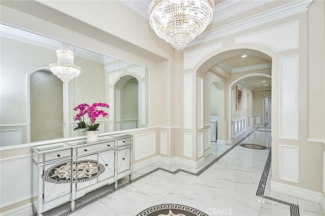 hall featuring crown molding and a notable chandelier