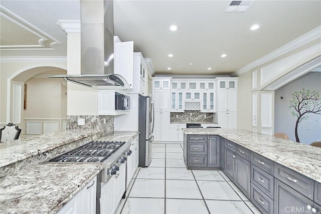 kitchen featuring gray cabinetry, decorative backsplash, island range hood, white cabinetry, and stainless steel appliances