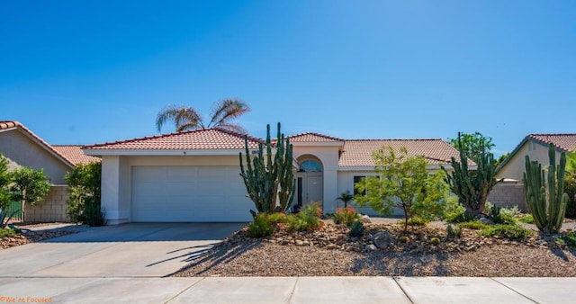 mediterranean / spanish house featuring a garage