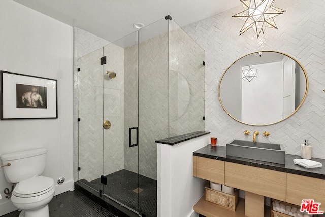 bathroom featuring vanity, tasteful backsplash, toilet, and walk in shower