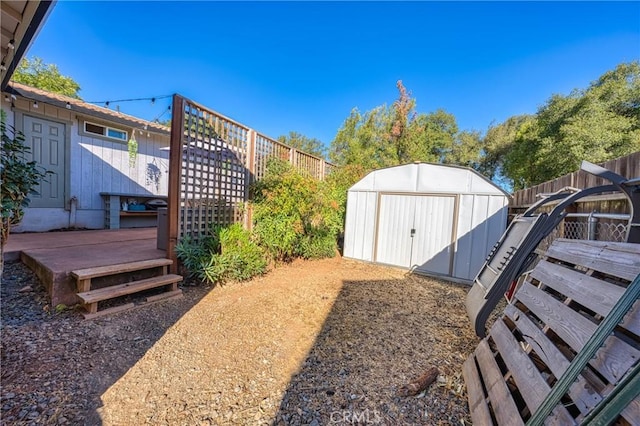 view of yard with a storage shed and a wooden deck