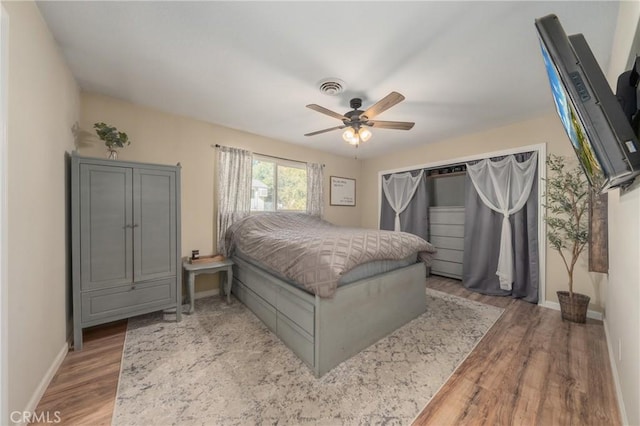 bedroom with ceiling fan and light hardwood / wood-style flooring