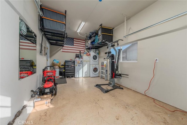 garage with stacked washer / drying machine