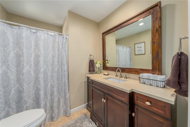 bathroom with toilet, tile patterned flooring, and vanity