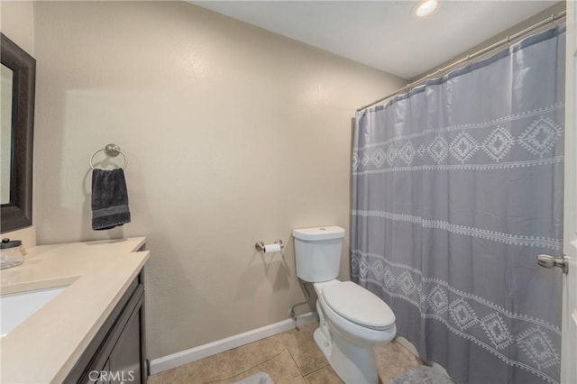 bathroom with tile patterned floors, vanity, toilet, and walk in shower