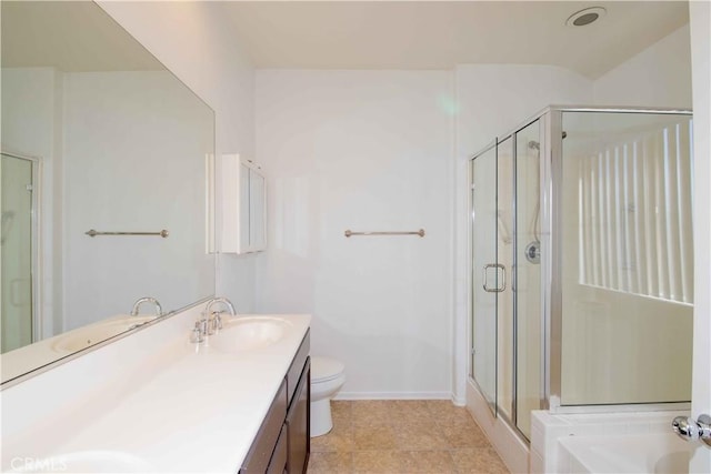 bathroom with tile patterned floors, vanity, toilet, and a shower with shower door