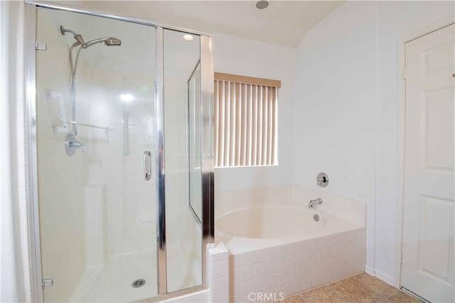 bathroom featuring tile patterned flooring and shower with separate bathtub