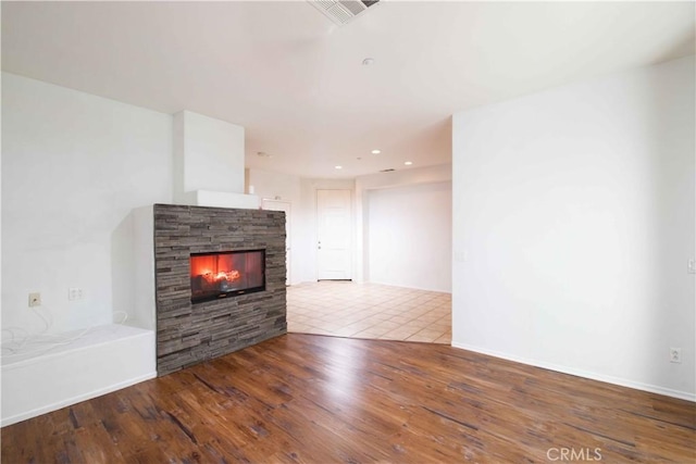 unfurnished living room with a fireplace and wood-type flooring