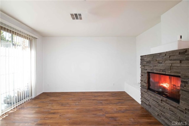 unfurnished living room with a fireplace and dark hardwood / wood-style flooring