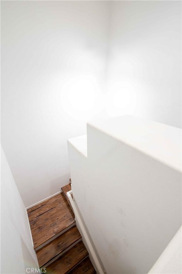 stairway featuring hardwood / wood-style flooring