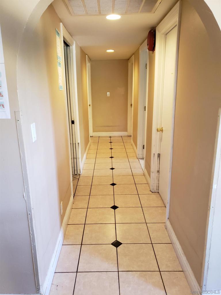 hall with light tile patterned floors