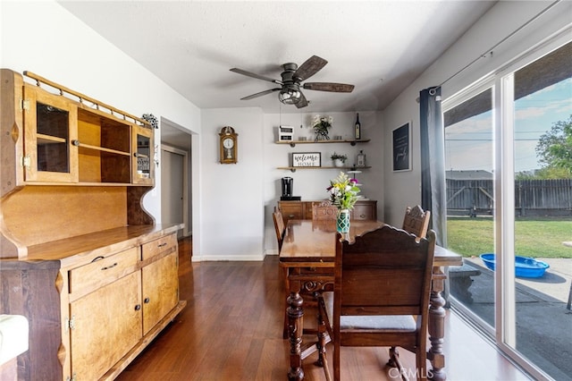 dining area with ceiling fan and dark hardwood / wood-style flooring