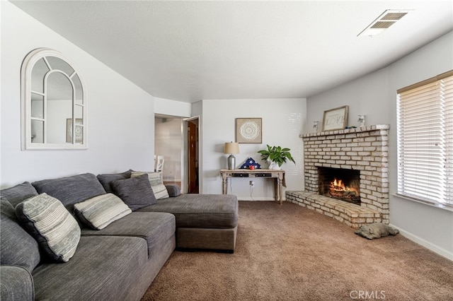 carpeted living room with a brick fireplace