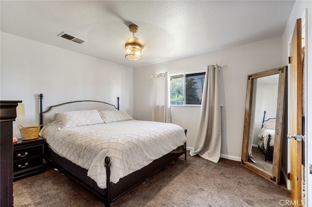 bedroom with carpet floors and a textured ceiling