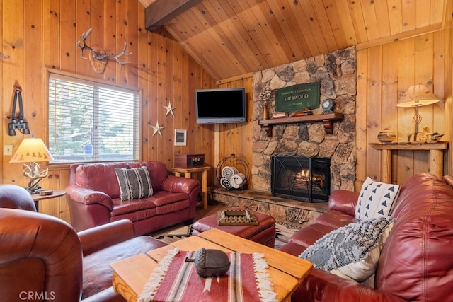 living room with vaulted ceiling with beams, wood ceiling, wooden walls, and a fireplace