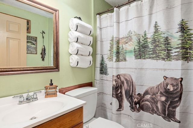 bathroom featuring toilet, walk in shower, and vanity