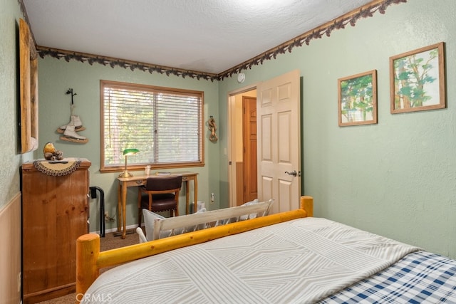 carpeted bedroom featuring a textured ceiling