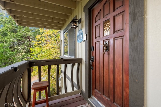 view of exterior entry with a balcony