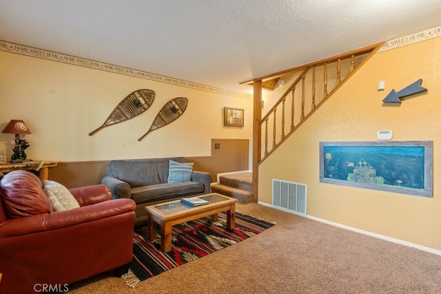 living room with a textured ceiling and carpet floors