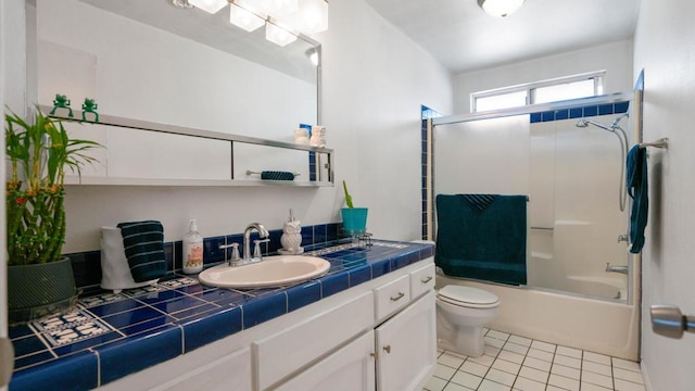 full bathroom with shower / bath combination with glass door, tile patterned flooring, vanity, and toilet