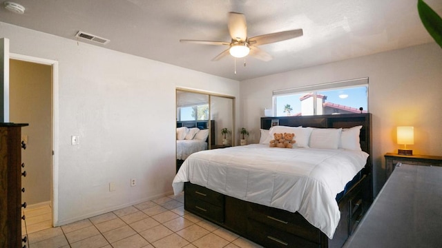 bedroom with ceiling fan, a closet, and light tile patterned floors