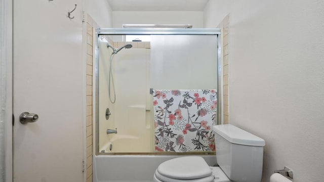 bathroom featuring toilet and enclosed tub / shower combo