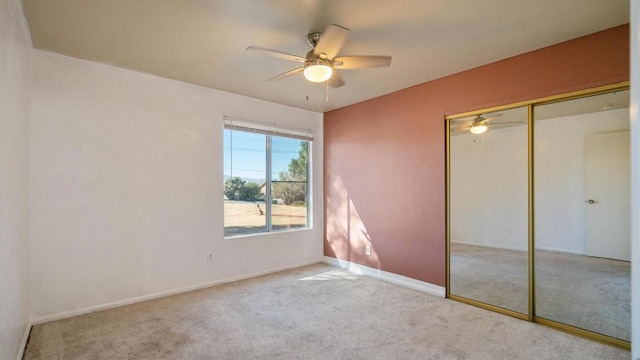 unfurnished bedroom featuring ceiling fan, a closet, and light carpet