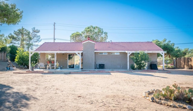 rear view of property with central AC