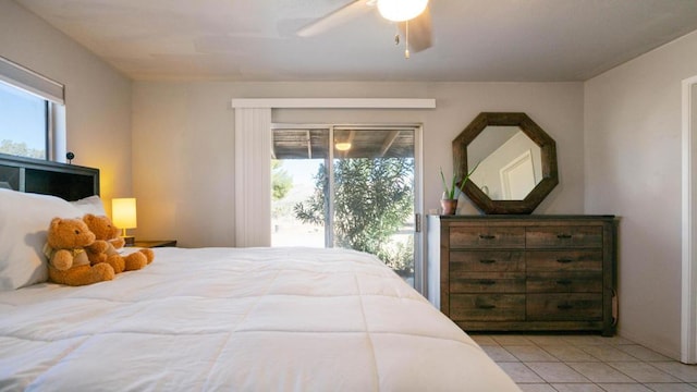 bedroom featuring light tile patterned flooring, access to outside, multiple windows, and ceiling fan