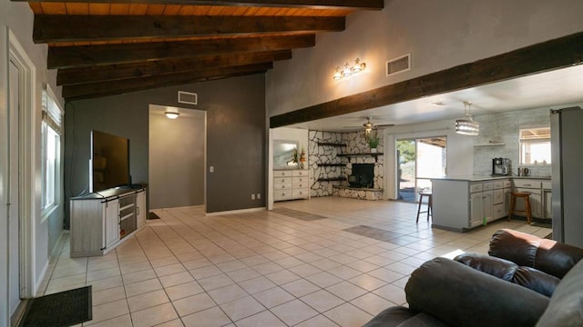 tiled living room featuring lofted ceiling with beams, ceiling fan, wooden ceiling, and a fireplace