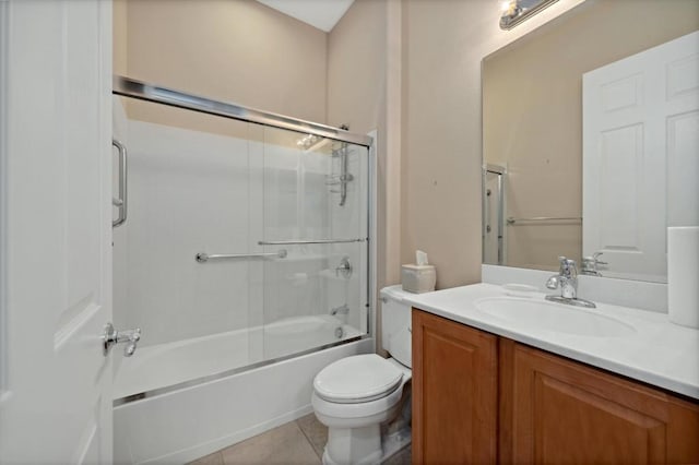 full bathroom with vanity, toilet, shower / bath combination with glass door, and tile patterned flooring