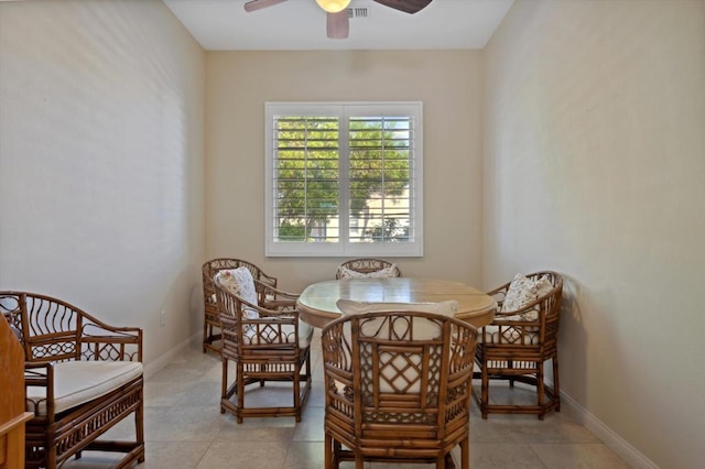 tiled dining space with ceiling fan