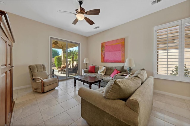 tiled living room with ceiling fan