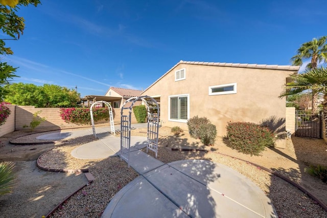 rear view of property featuring a patio