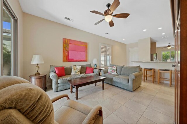 tiled living room with ceiling fan