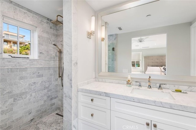 738 Cliff Dr, Laguna Beach, CA 92651 - bathroom featuring a tile shower, vanity, and ceiling fan