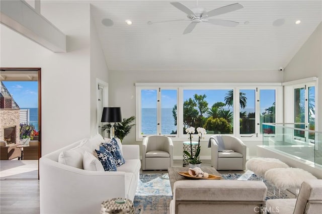 738 Cliff Dr, Laguna Beach, CA 92651 - living room featuring vaulted ceiling, wood finished floors, a ceiling fan, a water view, and recessed lighting