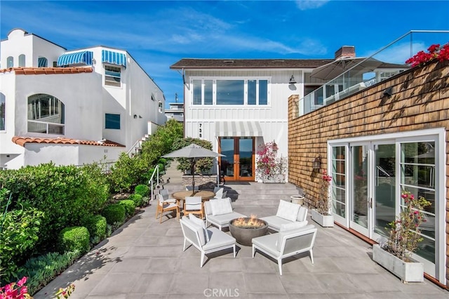 738 Cliff Dr, Laguna Beach, CA 92651 - view of patio with french doors and a fire pit