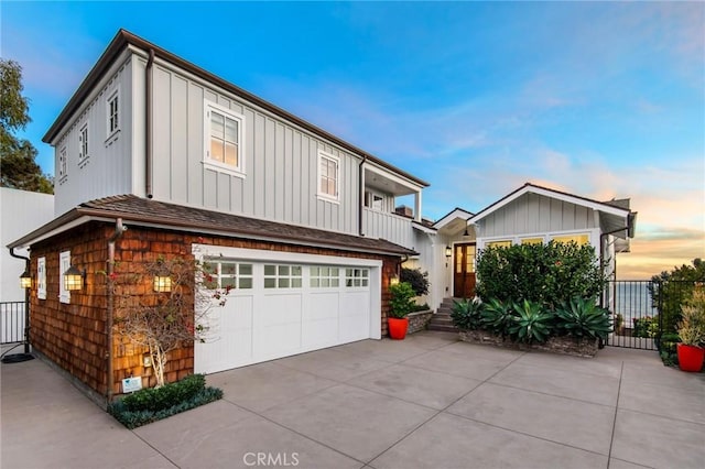 738 Cliff Dr, Laguna Beach, CA 92651 - view of front of property with board and batten siding, a garage, and driveway