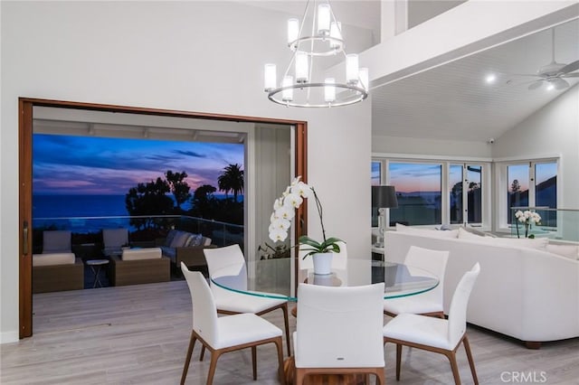 738 Cliff Dr, Laguna Beach, CA 92651 - dining room with a chandelier, wood finished floors, a ceiling fan, and high vaulted ceiling